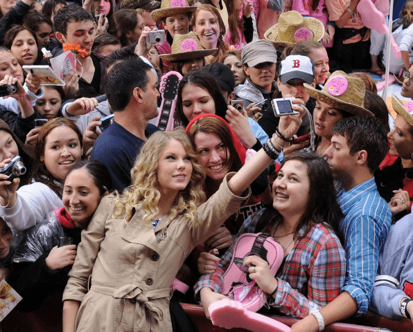 Taylor Swift takes pictures with fans. Source: Getty Images | Bryan Bedder