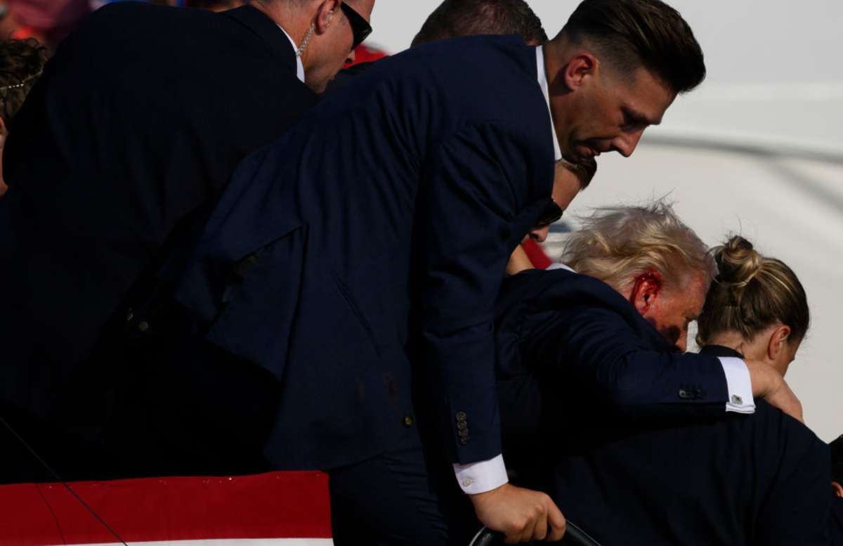 BUTLER, PENNSYLVANIA - JULY 13: Republican presidential candidate, former U.S. President Donald Trump is whisked away by Secret Service after shots rang out at a campaign rally at Butler Farm Show Inc. on July 13, 2024 in Butler, Pennsylvania. Trump slumped and injuries were visible to the side of his head. Butler County district attorney Richard Goldinger said the shooter and one audience member are dead and another was injured. (Photo by Jeff Swensen/Getty Images)