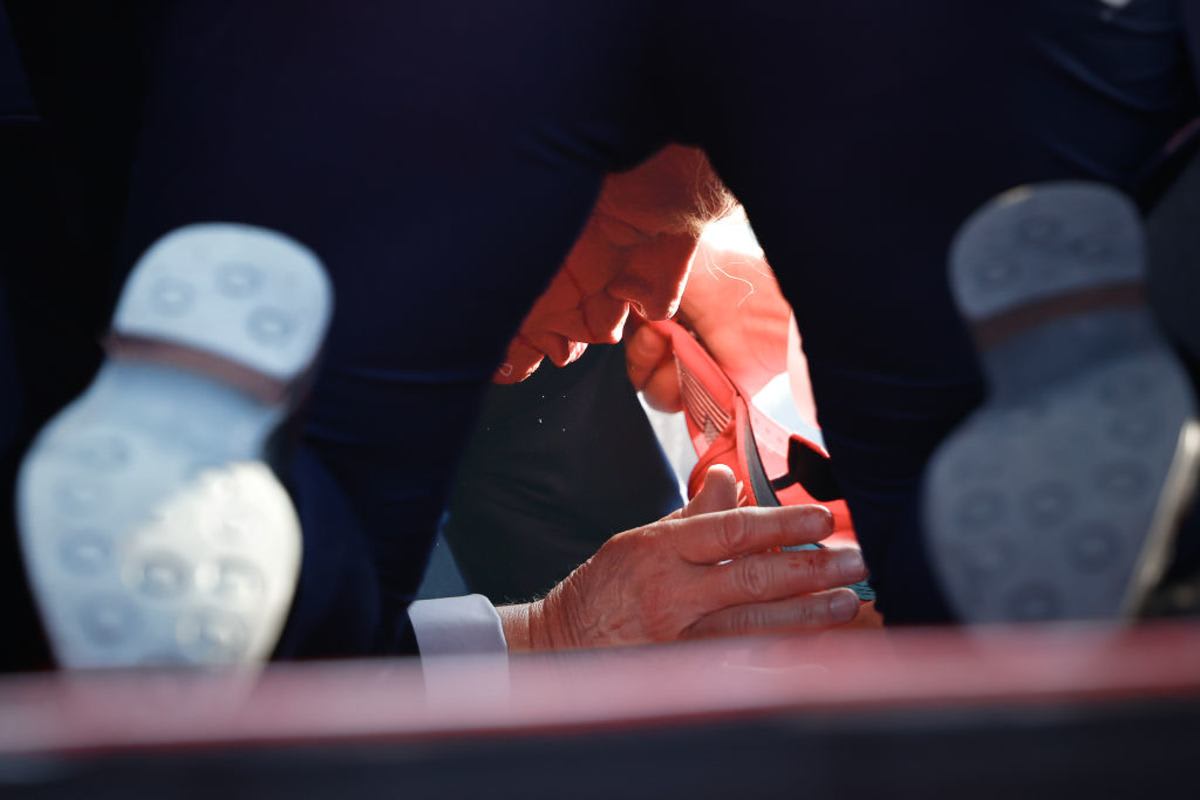 BUTLER, PENNSYLVANIA - JULY 13: Secret Service tend to republican presidential candidate former President Donald Trump onstage after he was grazed by a bullet at a rally on July 13, 2024, in Butler, Pennsylvania. (Photo by Anna Moneymaker/Getty Images)