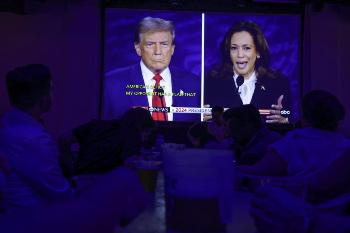 People watch the presidential debate during a debate watch party at Penn Social on September 10, 2024 in Washington, DC. (Image Source: Getty Images | Photo by Alex Wong)