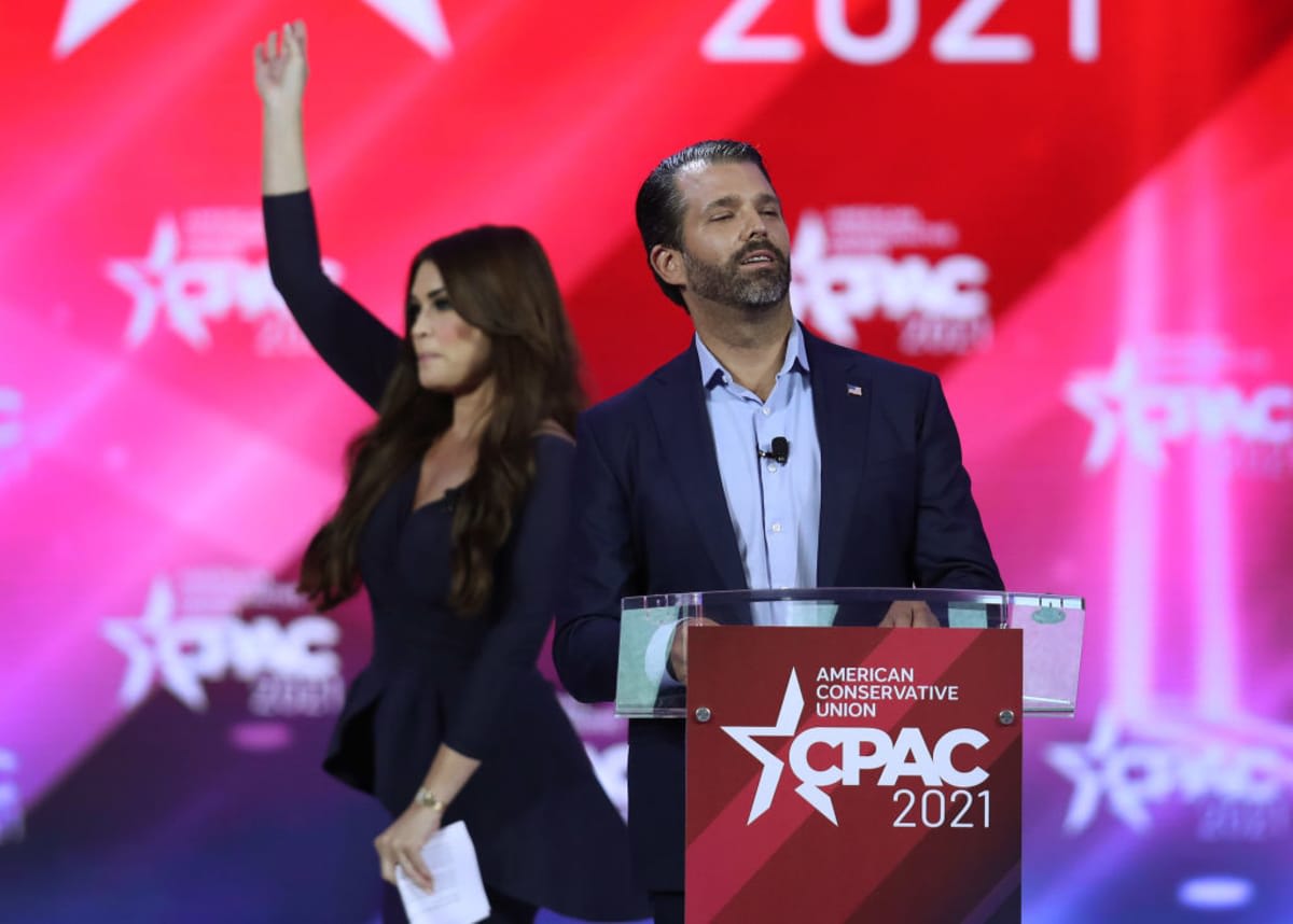 Don Trump, Jr. and Kimberly Guilfoyle stand on stage as they address the Conservative Political Action Conference being held in the Hyatt Regency on February 26, 2021, in Orlando, Florida. (Image Source: Joe Raedle/Getty Images)