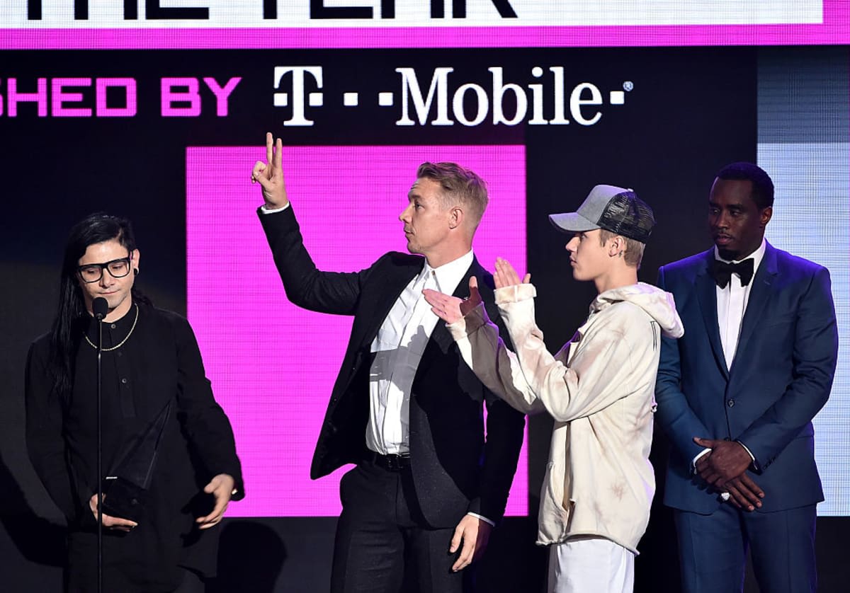 Skrillex, Diplo, and Justin Bieber accept Collaboration of the Year award for 'Where Are U Now' from Sean 'Diddy' Combs during the 2015 American Music Awards at Microsoft Theater on November 22, 2015, in LA, California. (Image Source: Getty Images| Photo by Kevin Winter) 