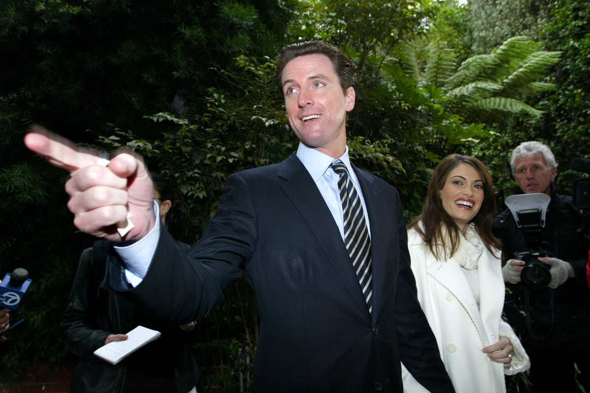 Cover Image Source: San Francisco mayoral candidate Gavin Newsom (L) and his wife Kimberly Guilfoyle-Newsom leave a polling place after they cast their ballots for the mayoral run-off election December 9, 2003 in San Francisco. Photo by Getty Images | Photo by Justin Sullivan