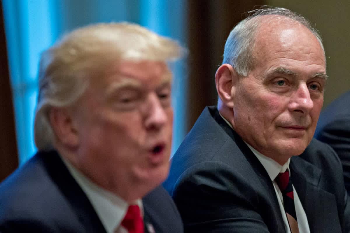 John Kelly listens as Donald Trump speaks at a briefing with senior military leaders on October 5, 2017, in Washington, D.C. (Image Source: Getty Images | Photo By Andrew Harrer)