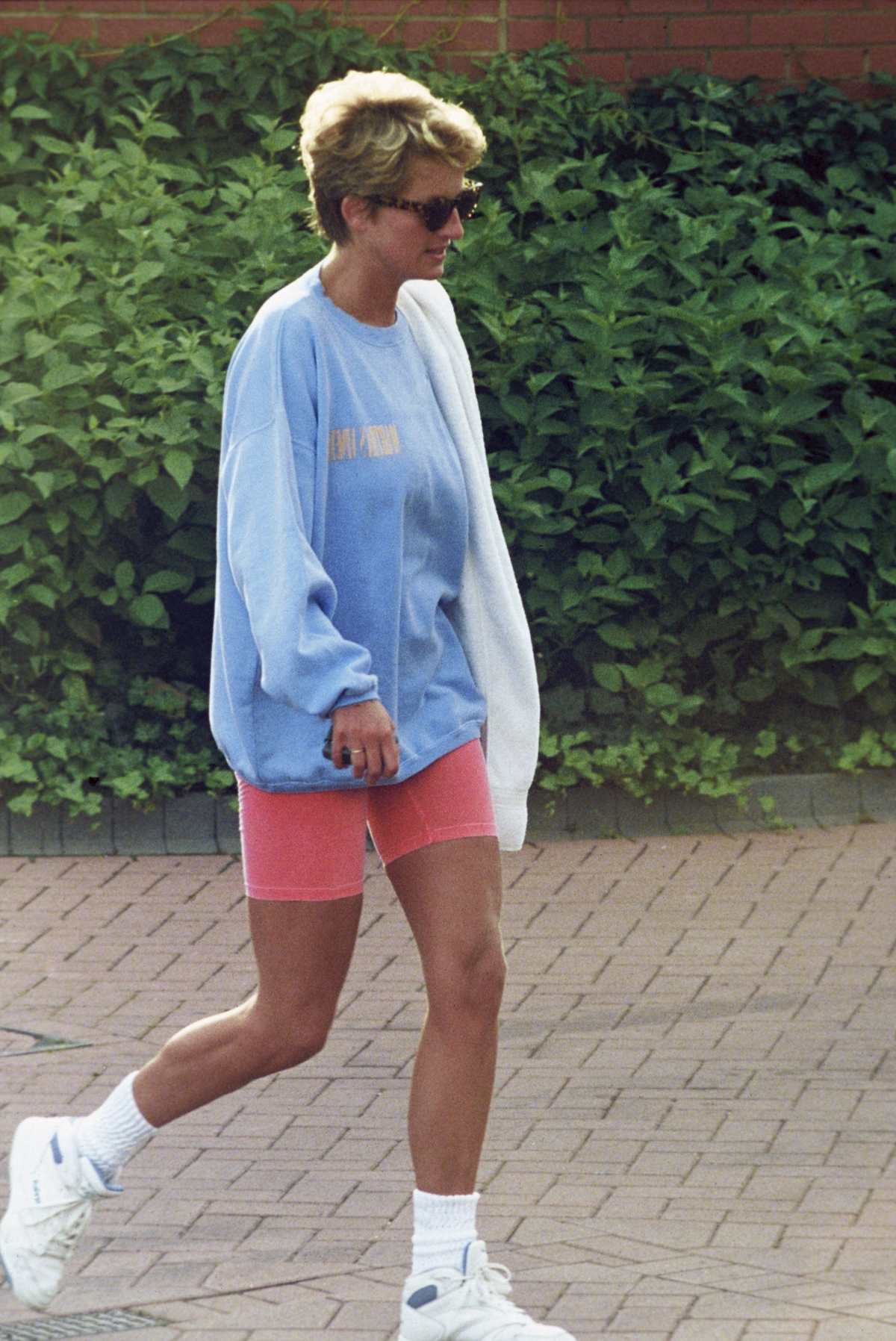 Image Source: Diana, Princess of Wales, wearing a pale blue sweatshirt, pink cycling shorts and sunglasses, leaves Chelsea Harbour Club on August 24, 1994 in London, United Kingdom. Getty Images | Photo by Anwar Hussein