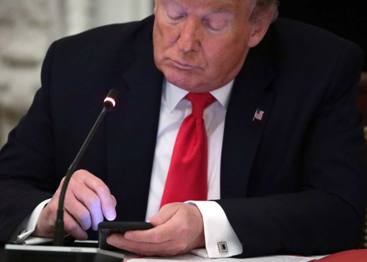 Trump works on his phone during a roundtable at the State Dining Room of the White House on June 18, 2020. (Cover Image Source: Photo by Alex Wong/ Getty Images)