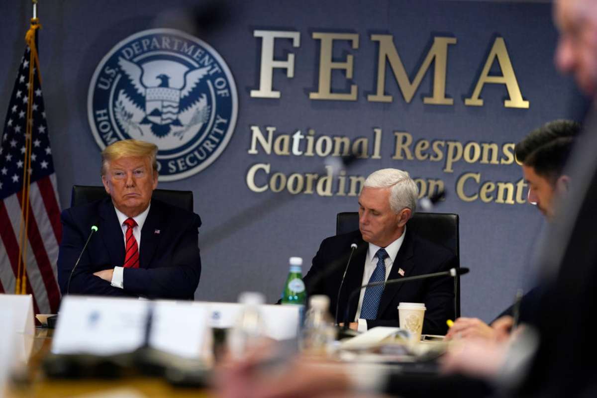 Donald Trump (L) and Vice President Mike Pence attend a teleconference with governors at the Federal Emergency Management Agency. (Image Source: Photo by Evan Vucci-Pool/Getty Images)