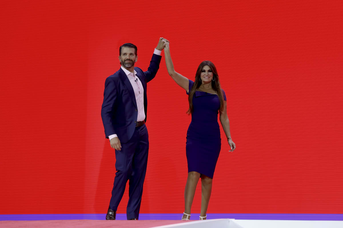 Donald Trump Jr. high-fives Kimberly Guilfoyle before speaking at the annual Conservative Political Action Conference (CPAC). Image Source: Photo by Anna Moneymaker | Getty Images 