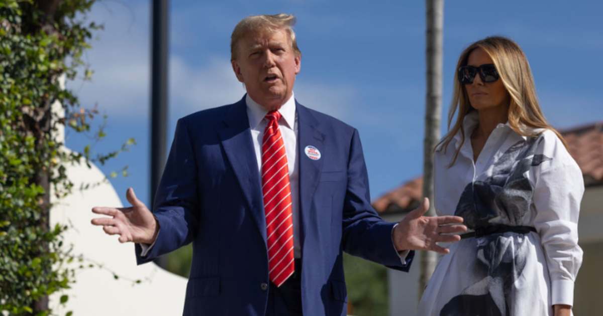 Donald Trump and former first lady Melania Trump stand together as they speak with the media after voting at a polling station setup in the Morton and Barbara Mandel Recreation Center on March 19, 2024, in Palm Beach, Florida.  (Image Source: Getty Images | Photo By Joe Raedle)