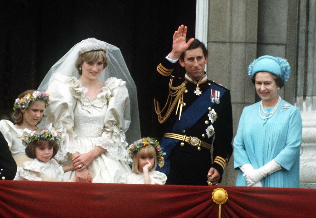 The Prince and Princess of Wales pose on the balcony of Buckingham Palace on their wedding day, with the Queen. (Image Source: Photo by Terry Fincher | Getty Images 