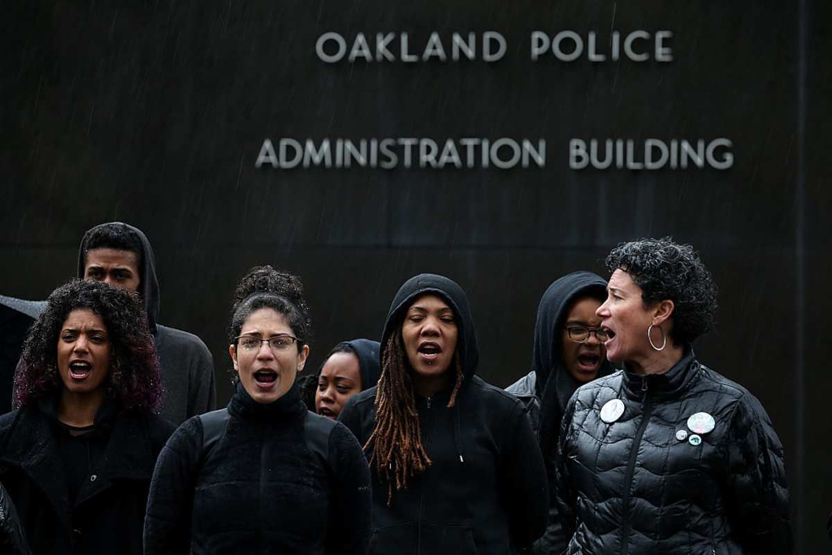 Protestors assemble in front of the Oakland police department headquarters during a demonstration over recent grand jury decisions in police-involved deaths on December 15, 2014 in Oakland, California. (Image Source: Photo by Justin Sullivan/Getty Images)