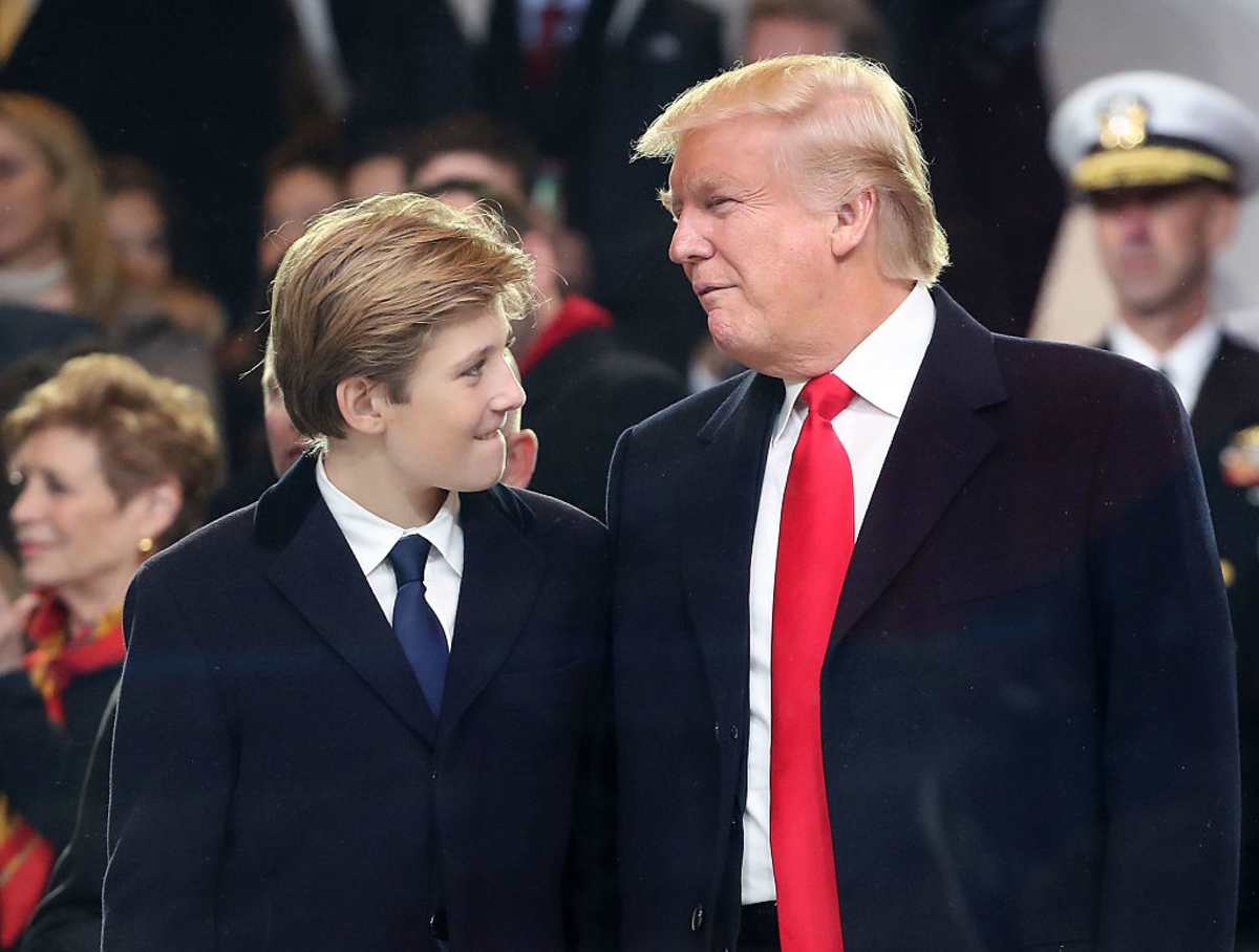 Donald Trump stands with his son Barron Trump inside of the inaugural parade reviewing stand in front of the White House on January 20, 2017 in Washington, DC. (Image Source:  Mark Wilson/Getty Images)