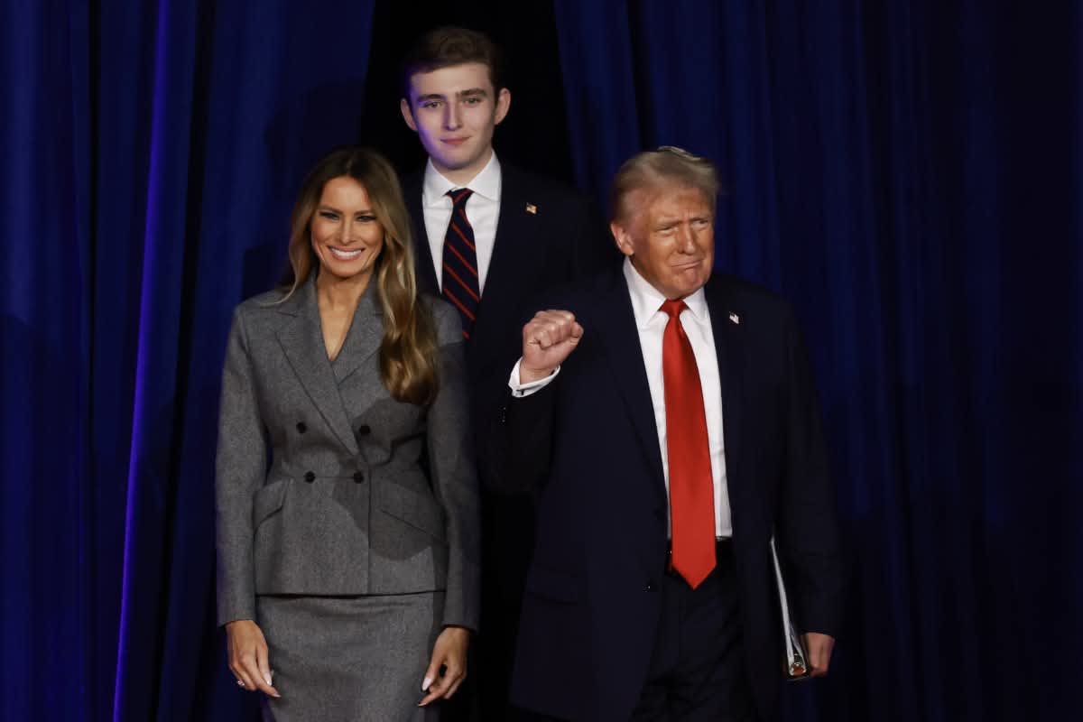 Donald Trump arrives to speak with former first lady Melania Trump and Barron Trump during an election night event at the Palm Beach Convention Center. Image Source: Getty Images | Photo by Joe Raedle