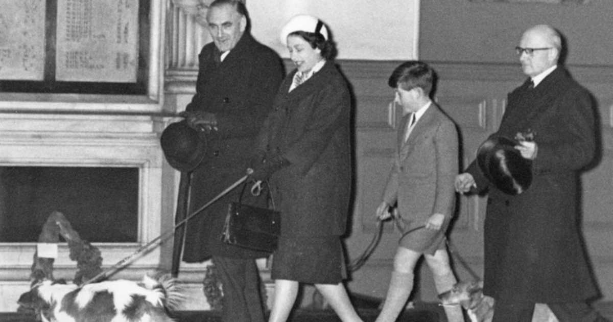 Queen Elizabeth II and Prince Charles walk through Liverpool Street Station in London with their dogs, having returned by train from Sandringham after the Christmas holidays, 18th January 1960.  (Image Source: Getty Images | Photo By Derek Berwin)