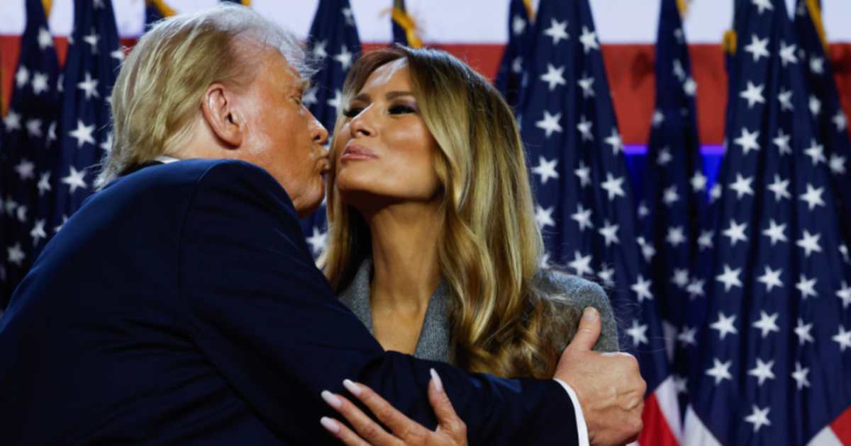 Donald Trump kisses Melania Trump as he arrives to speak during an election night event on November 06, 2024 in West Palm Beach, Florida.  (Image Source: Getty Images | Photo By Chip Somodevilla)