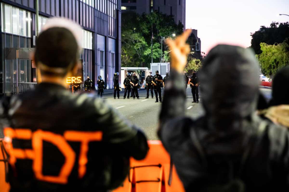 Protesters confront Oakland police members during a march on July 25, 2020 in Oakland, California. Demonstrators in Oakland gathered to protest in solidarity with Portland protests. (Image Source: Photo by Natasha Moustache/Getty Images)