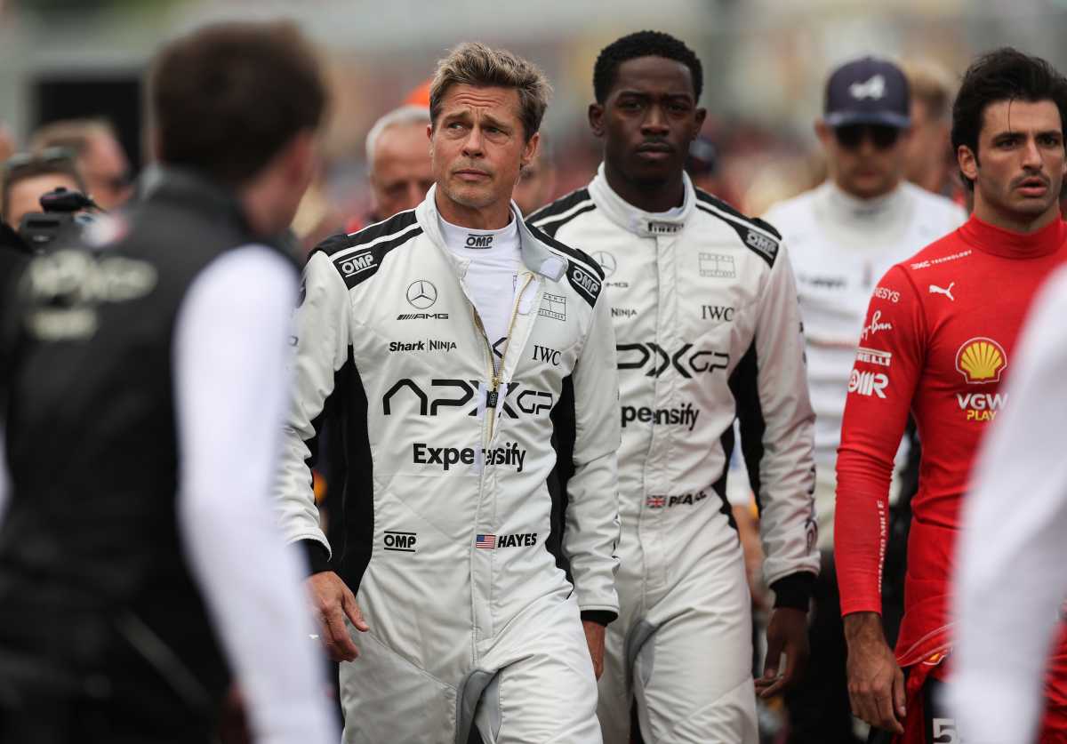 Brad Pitt, star of the upcoming Formula One movie Apex, walks on the grid in front of Carlos Sainz in the Ferrari SF-23 during the F1 Grand Prix of Great Britain at Silverstone Circuit on July 9, 2023. (Cover Image Source: Ryan Pierse/Getty Images)