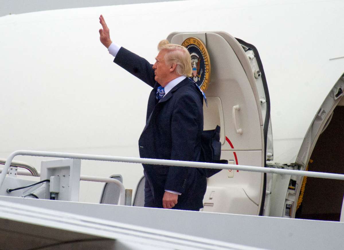 Donald Trump waves as he boards Air Force One to fly to Lynchburg. (Image Source: Photo by Ron Sachs-Pool/Getty Images)