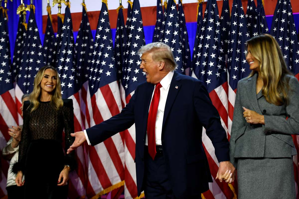 Donald Trump on stage with Lara Trump (L) and former first lady Melania Trump (R) after the 2024 election. (Image Source: Chip Somodevilla/Getty Images)