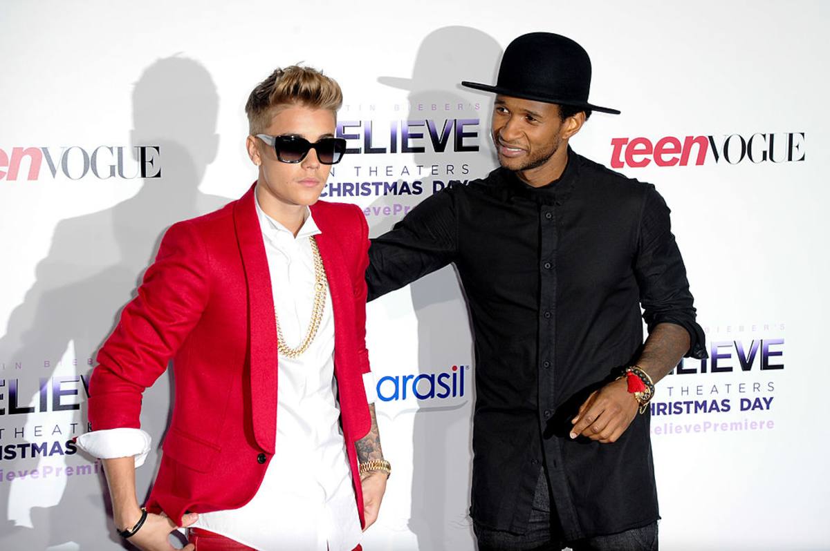 Justin Bieber & Usher at Regal Cinemas L.A. Live on December 18, 2013, in Los Angeles, California. (Image Source: Getty Images| Photo by Allen Berezovsky) 