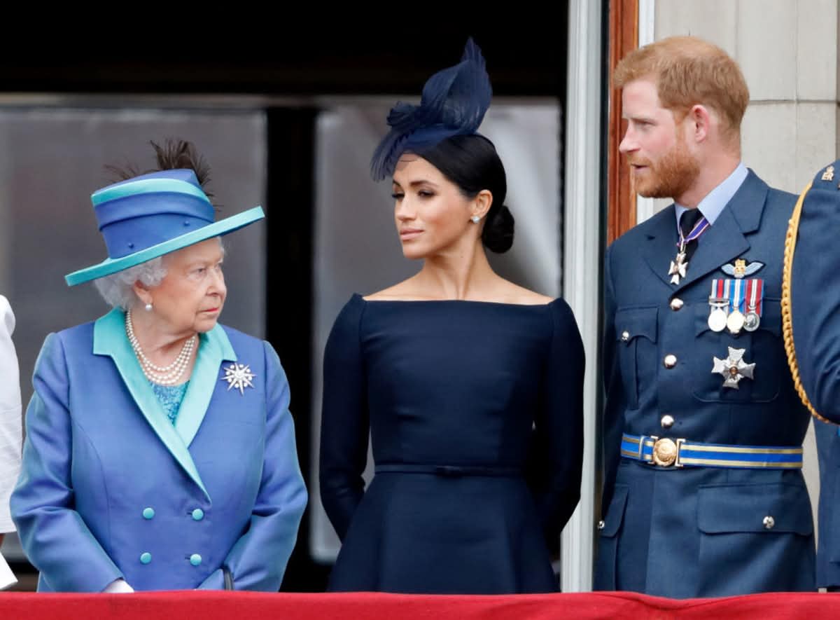 Queen Elizabeth II, Meghan Markle and Prince Harry at Buckingham Palace on July 10, 2018 in London. (Image Source: Getty Images | Photo by Max Mumby)