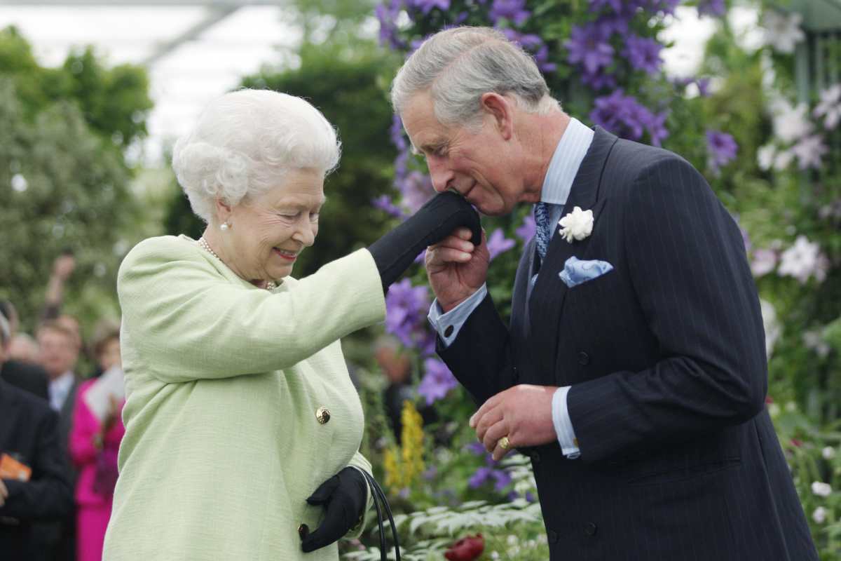 Queen Elizabeth II presents Prince Charles, Prince of Wales with the Royal Horticultural Society's Victoria Medal of Honour during a visit to the Chelsea Flower Show on May 18, 2009 in London. (Cover Image Source: Getty Images | Photo by Sang Tan/WPA Pool)