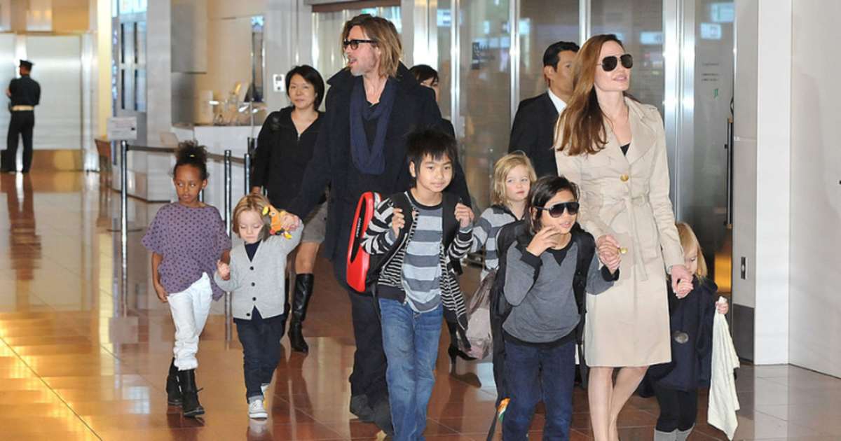 Brad Pitt, Angelina Jolie, and their six children Maddox, Pax, Zahara, Shiloh, Knox, and Vivienne arrive at Haneda International Airport on November 8 in Tokyo, Japan. (Image Source: Getty Images | Photo By  Jun Sato)