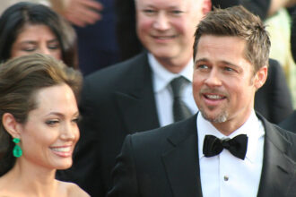 Angelina Jolie and Brad Pitt at a red carpet event.