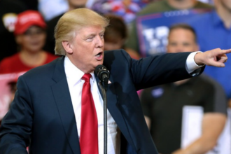 Donald Trump speaking with supporters at a campaign rally.