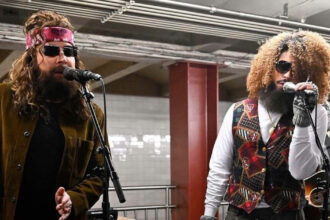 Jimmy Fallon (L) and Bad Bunny perform at a subway station in New York.